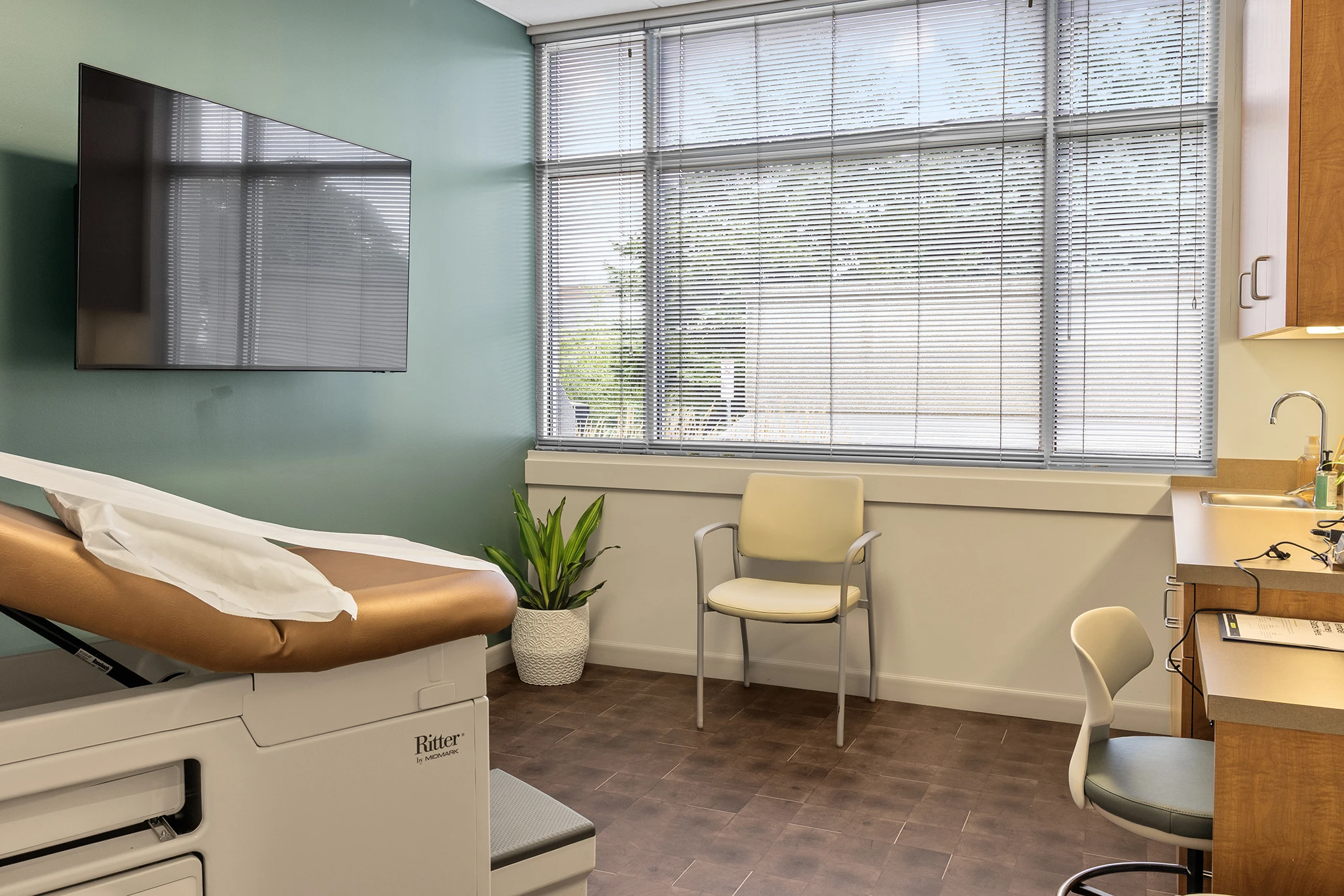 True Health Buffalo Grove concierge medicine exam room with natural light, exam table, and warm modern design