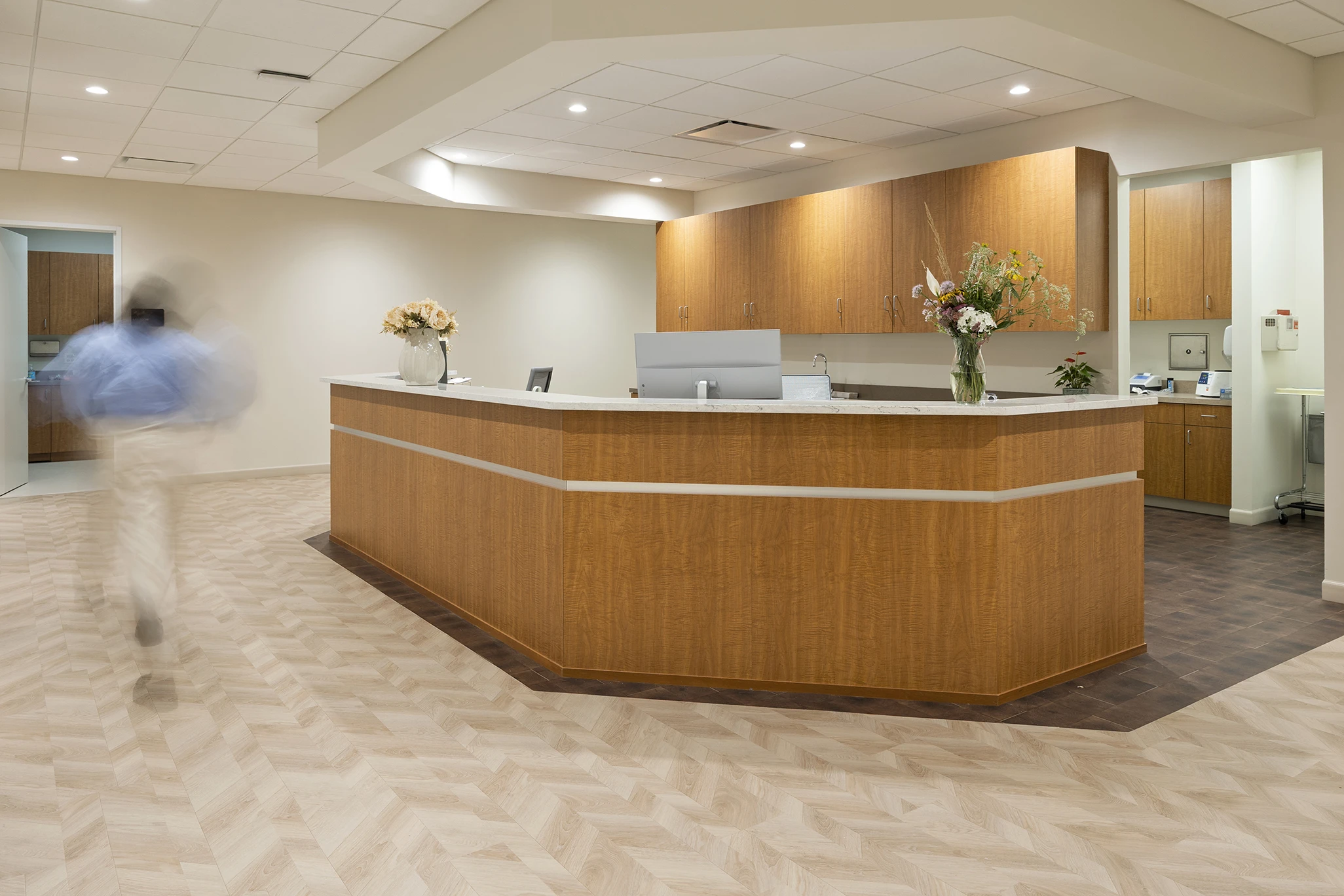True Health Buffalo Grove medical hub and nursing station with warm wood finishes and fresh flowers