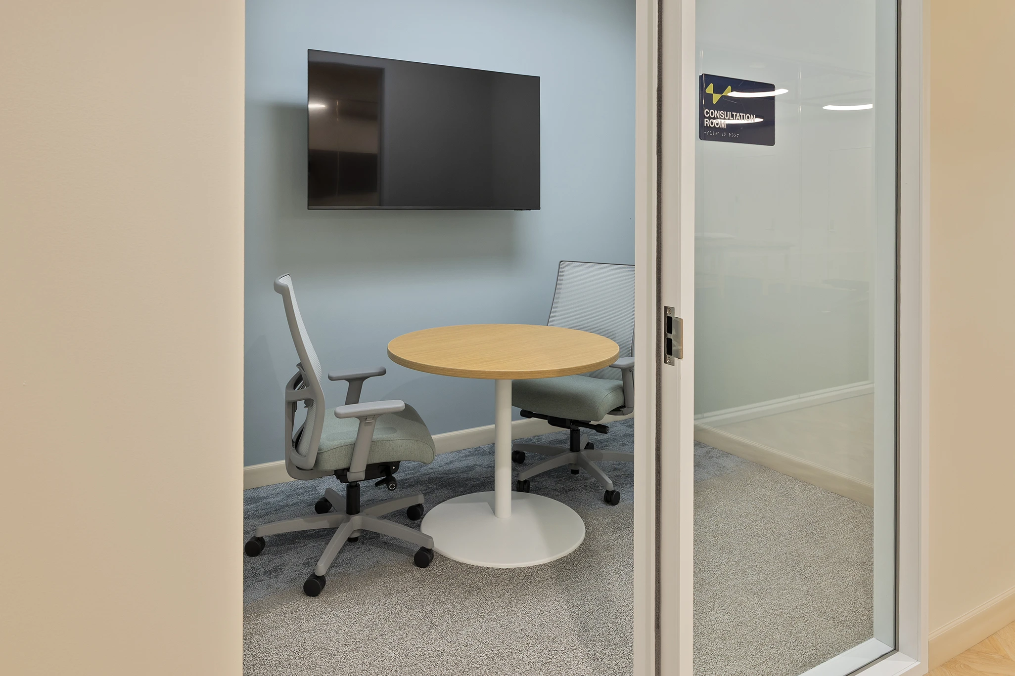 True Health Buffalo Grove private consultation room with round table and display screen for patient meetings